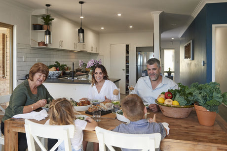 The Glavocich family sitting at a table eating fresh local Australian produce